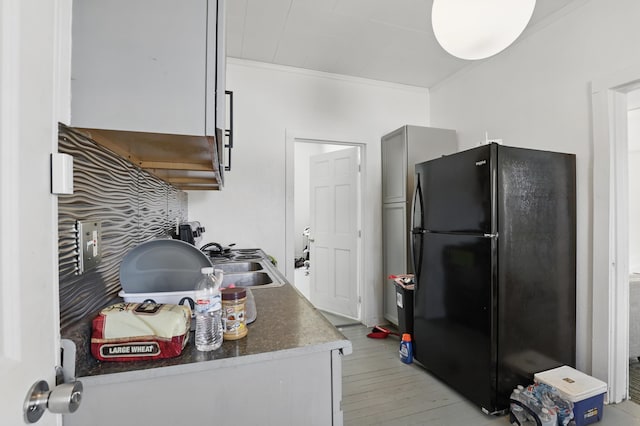 101 E Summit St, Lead, SD 57754 - kitchen with freestanding refrigerator, ornamental molding, a sink, and light wood-type flooring