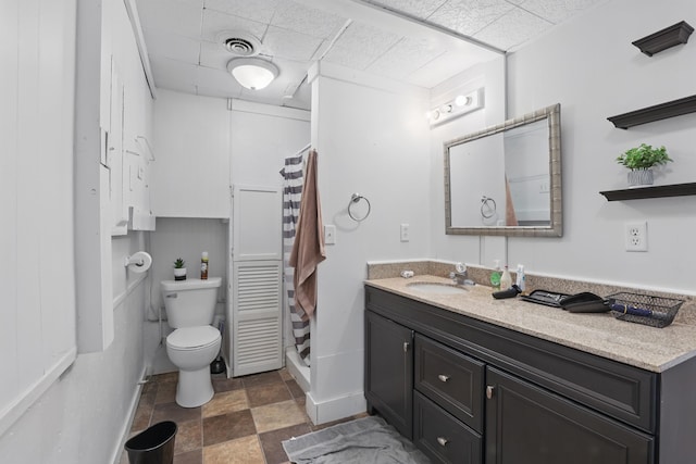 101 E Summit St, Lead, SD 57754 - full bathroom with a drop ceiling, a shower stall, toilet, vanity, and baseboards