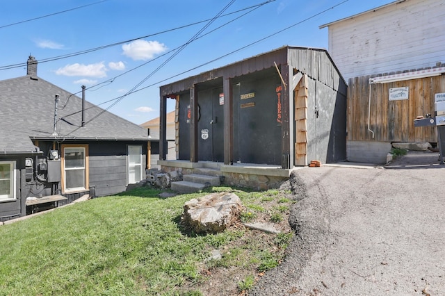 101 E Summit St, Lead, SD 57754 - back of house featuring an outbuilding and roof with shingles