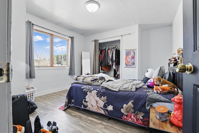 101 E Summit St, Lead, SD 57754 - bedroom with wood finished floors, baseboards, and a closet