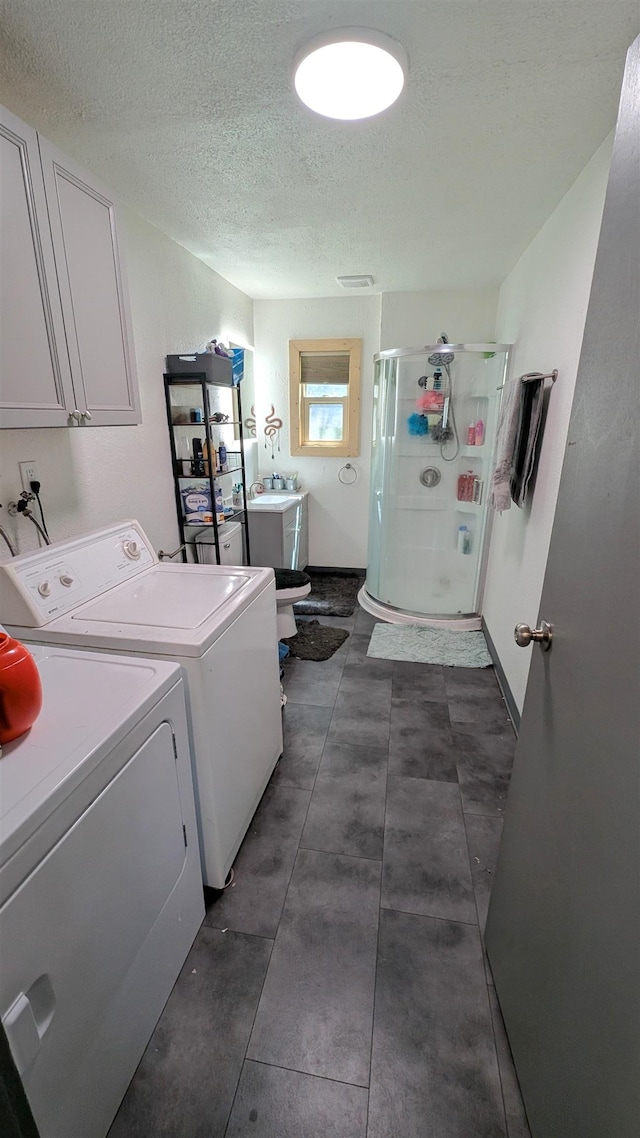 125 S Galena St, Lead, SD 57754 - washroom with washing machine and dryer, cabinet space, and a textured ceiling