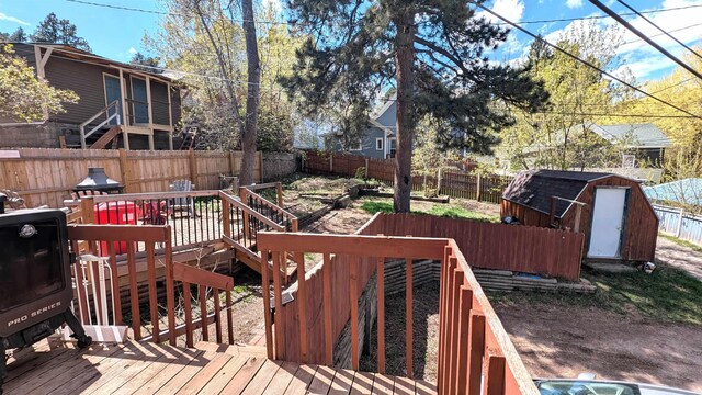 125 S Galena St, Lead, SD 57754 - deck featuring a storage unit, a fenced backyard, an outdoor structure, and stairway