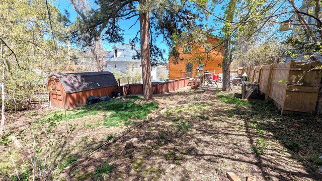125 S Galena St, Lead, SD 57754 - fenced backyard featuring a storage unit and an outdoor structure