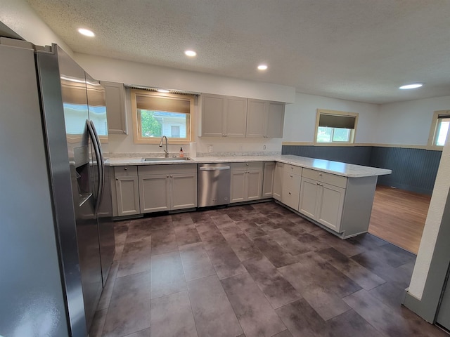 125 S Galena St, Lead, SD 57754 - kitchen featuring appliances with stainless steel finishes, a sink, wainscoting, a peninsula, and light countertops