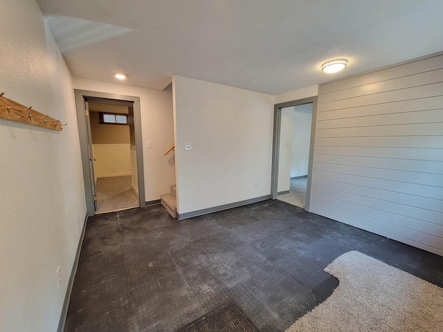 125 S Galena St, Lead, SD 57754 - spare room with stairway, baseboards, a textured ceiling, and dark carpet