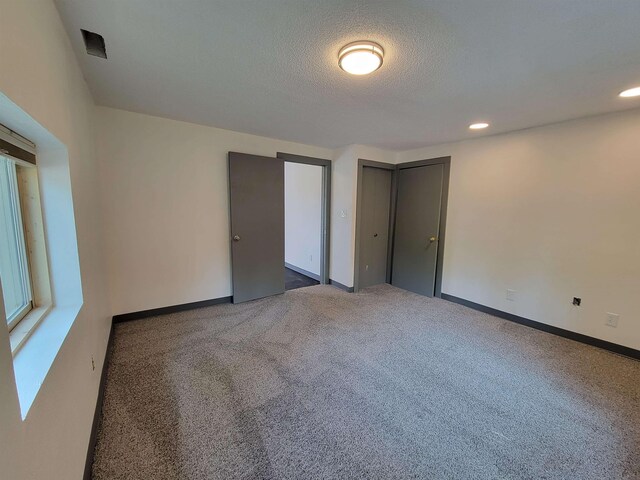 125 S Galena St, Lead, SD 57754 - unfurnished bedroom with carpet floors, a textured ceiling, baseboards, recessed lighting, and a closet