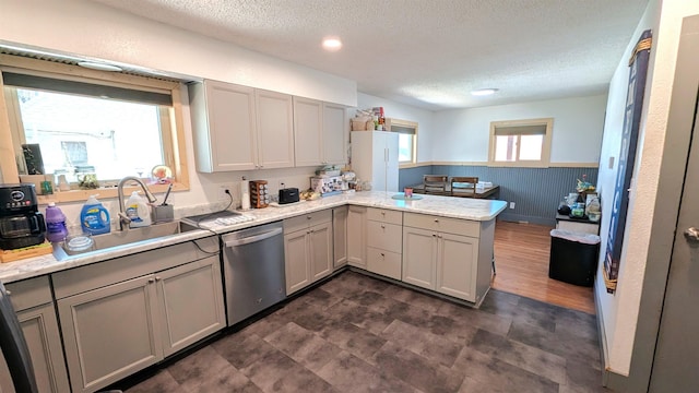 125 S Galena St, Lead, SD 57754 - kitchen featuring dishwasher, a sink, a peninsula, a textured ceiling, and light countertops