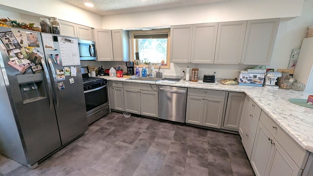 125 S Galena St, Lead, SD 57754 - kitchen with appliances with stainless steel finishes, a sink, gray cabinetry, a textured ceiling, and recessed lighting