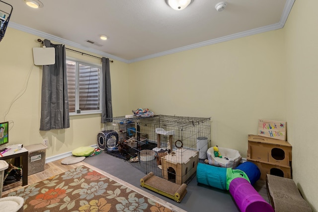 4103 Waterville Ct, Rapid City, SD 57702 - playroom featuring wood finished floors, crown molding, and baseboards