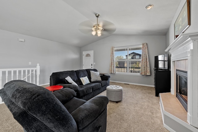 4103 Waterville Ct, Rapid City, SD 57702 - living area with ceiling fan, light colored carpet, vaulted ceiling, baseboards, and a tiled fireplace