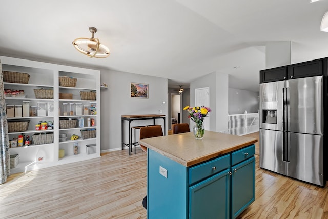 4103 Waterville Ct, Rapid City, SD 57702 - kitchen featuring stainless steel fridge, light wood-style floors, a center island, and blue cabinets