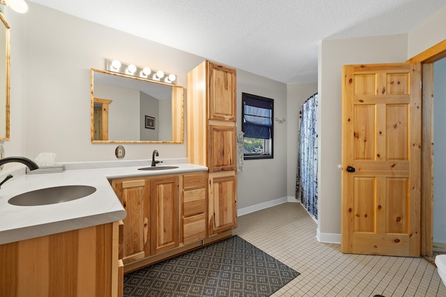 12990 Old Hill City Rd, Keystone, SD 57751 - full bathroom featuring double vanity, tile patterned floors, a textured ceiling, and a shower with shower curtain