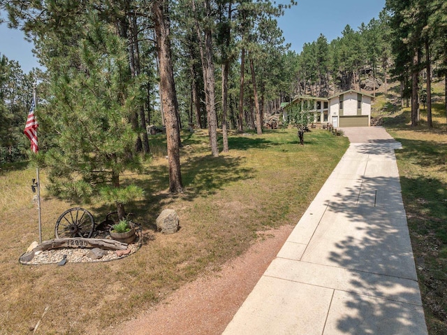 12990 Old Hill City Rd, Keystone, SD 57751 - view of front of property featuring driveway, a front lawn, and a garage