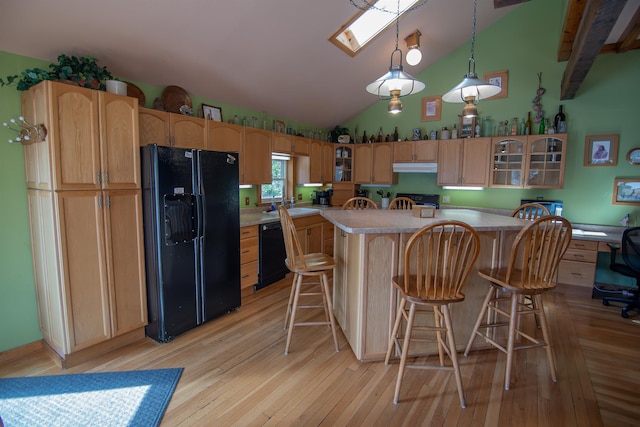 10 Centennial Ave, Deadwood, SD 57732 - kitchen featuring black appliances, under cabinet range hood, light countertops, a sink, and light wood-style floors