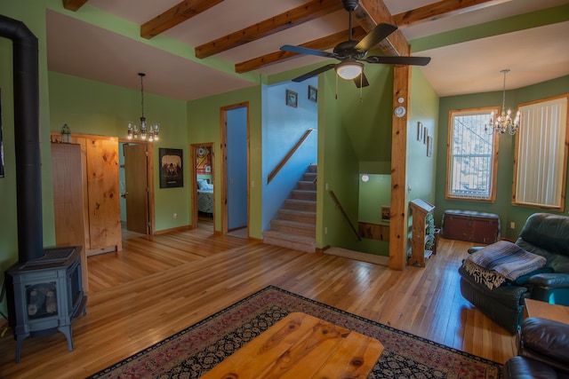 10 Centennial Ave, Deadwood, SD 57732 - living room with a chandelier, a wood stove, wood finished floors, a ceiling fan, and beam ceiling