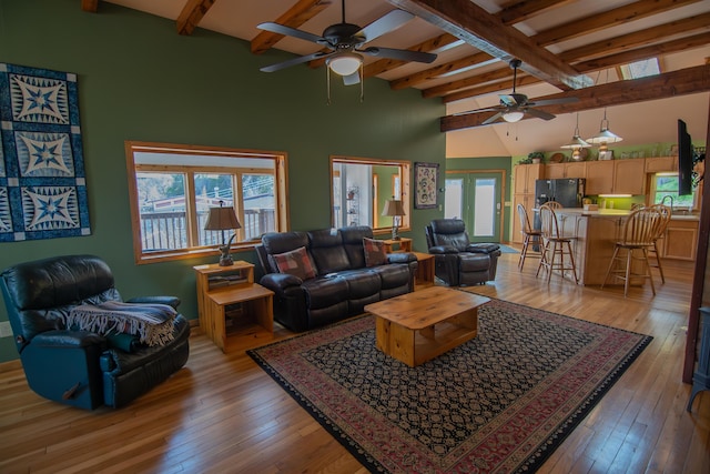 10 Centennial Ave, Deadwood, SD 57732 - living room with a ceiling fan, beam ceiling, a towering ceiling, and light wood-style floors