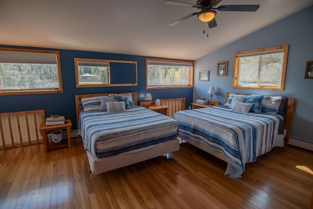 10 Centennial Ave, Deadwood, SD 57732 - bedroom featuring radiator, hardwood / wood-style floors, lofted ceiling, multiple windows, and a baseboard heating unit