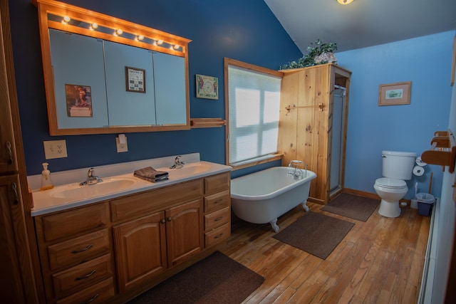10 Centennial Ave, Deadwood, SD 57732 - full bathroom with vaulted ceiling, a shower stall, wood finished floors, a soaking tub, and toilet