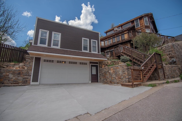 10 Centennial Ave, Deadwood, SD 57732 - view of front of home with a garage, stone siding, stairway, and fence