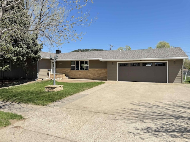 single story home featuring a garage, driveway, a front yard, and brick siding