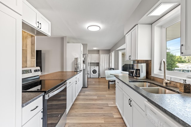 kitchen featuring stainless steel range with electric cooktop, a sink, washing machine and clothes dryer, dishwasher, and white cabinets