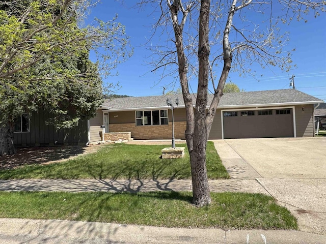 ranch-style home featuring an attached garage, driveway, a front yard, and roof with shingles