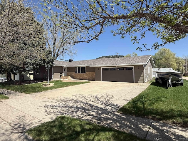 ranch-style house featuring a garage, a front lawn, driveway, and a chimney
