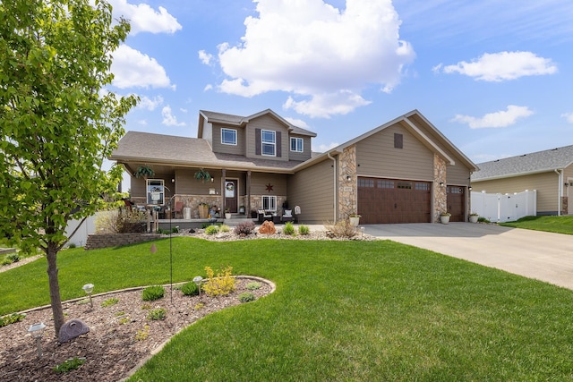 4127 Quiment Ct, Rapid City, SD 57702 - view of front facade with a porch, concrete driveway, an attached garage, and stone siding