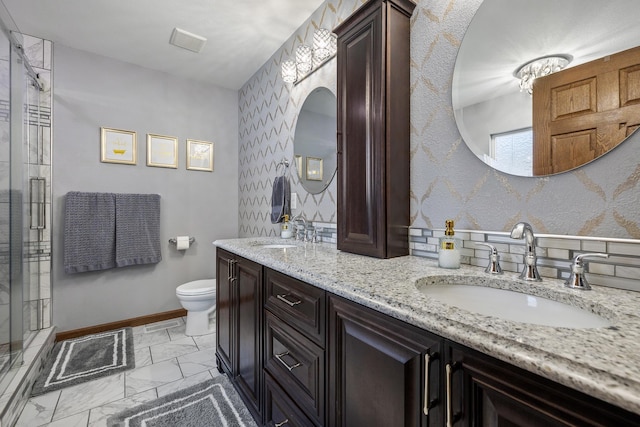4127 Quiment Ct, Rapid City, SD 57702 - bathroom with toilet, baseboards, a shower stall, double vanity, and marble look tiles