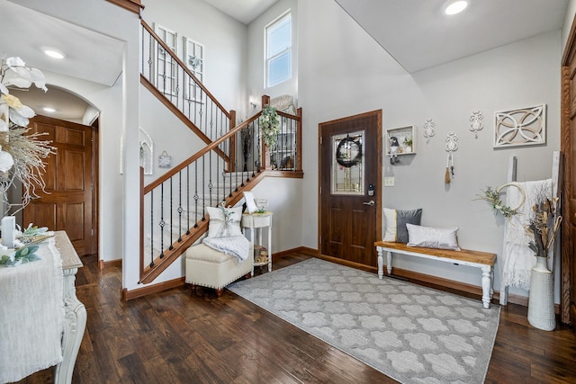 4127 Quiment Ct, Rapid City, SD 57702 - entryway featuring arched walkways, wood finished floors, baseboards, stairway, and a high ceiling