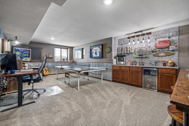 4127 Quiment Ct, Rapid City, SD 57702 - recreation room featuring beverage cooler, bar with sink, light colored carpet, a textured ceiling, and an office area
