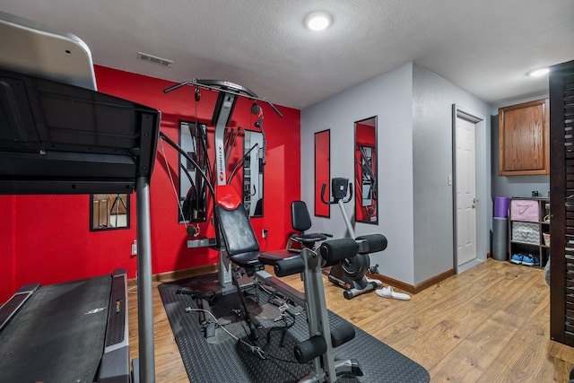 4127 Quiment Ct, Rapid City, SD 57702 - workout area with wood finished floors, baseboards, and a textured ceiling