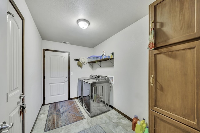 1234 Juneau Dr, Box Elder, SD 57719 - laundry room featuring independent washer and dryer, baseboards, and a textured ceiling