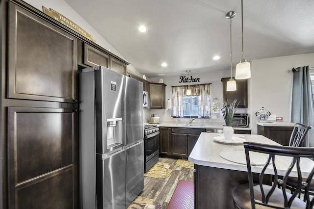 1234 Juneau Dr, Box Elder, SD 57719 - kitchen featuring stainless steel appliances, light countertops, dark brown cabinetry, light wood-style flooring, and hanging light fixtures