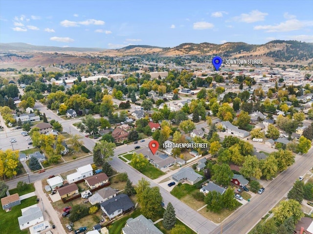 1542 Davenport St, Sturgis, SD 57785 - aerial overview of property's location with a mountainous background and nearby suburban area