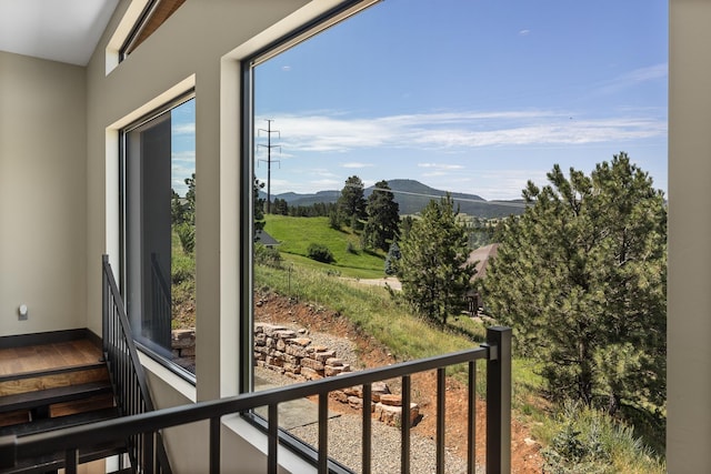 doorway to outside with a mountain view and baseboards