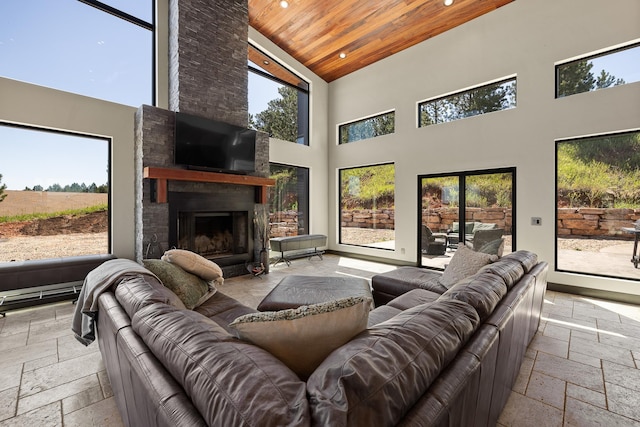 living room with stone tile flooring, high vaulted ceiling, wood ceiling, healthy amount of natural light, and recessed lighting