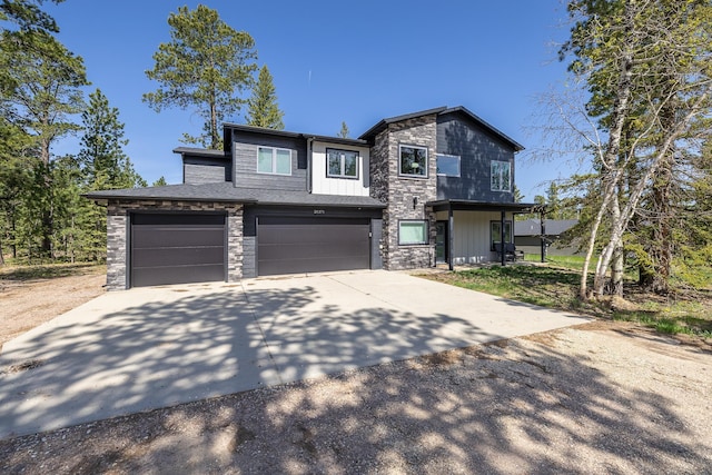 21271 Ridgewood Trl, Lead, SD 57754 - view of front of house with an attached garage, concrete driveway, and stone siding
