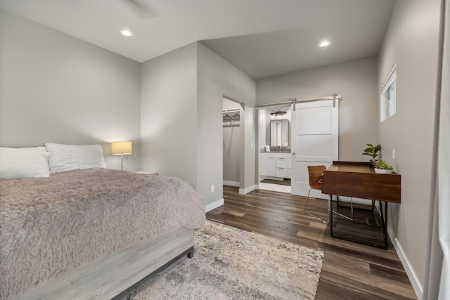 21271 Ridgewood Trl, Lead, SD 57754 - bedroom with baseboards, dark wood-style floors, recessed lighting, a barn door, and a closet