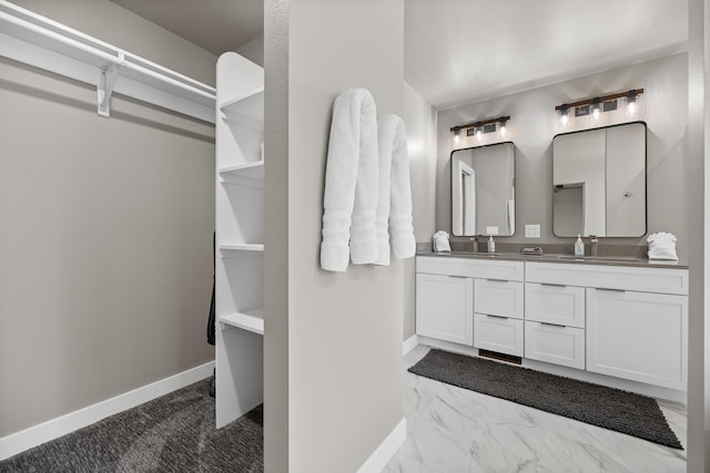 21271 Ridgewood Trl, Lead, SD 57754 - bathroom featuring baseboards, double vanity, and a walk in closet