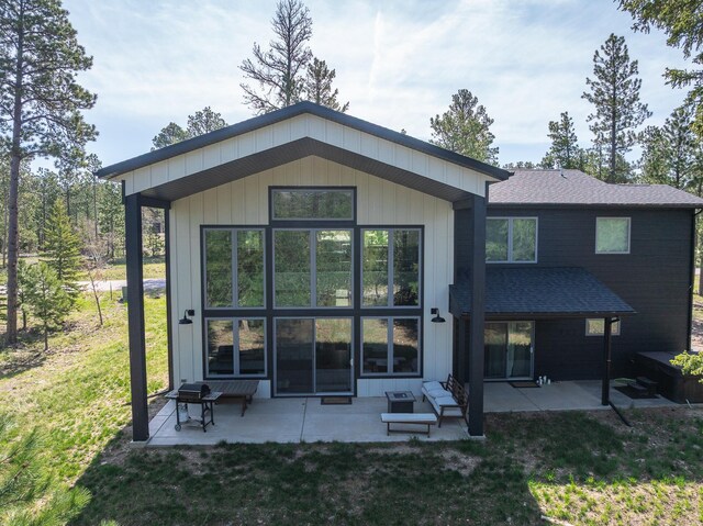 21271 Ridgewood Trl, Lead, SD 57754 - rear view of house featuring a shingled roof, a patio area, and a lawn