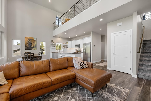 21271 Ridgewood Trl, Lead, SD 57754 - living area featuring stairway, dark wood-style floors, a towering ceiling, baseboards, and recessed lighting