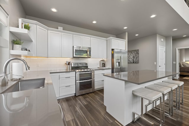 21271 Ridgewood Trl, Lead, SD 57754 - kitchen with stainless steel appliances, open shelves, a sink, dark wood finished floors, and white cabinetry