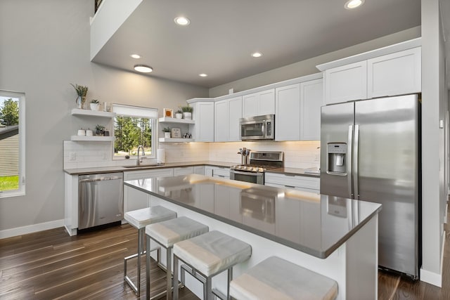 21271 Ridgewood Trl, Lead, SD 57754 - kitchen with appliances with stainless steel finishes, open shelves, dark countertops, tasteful backsplash, and recessed lighting