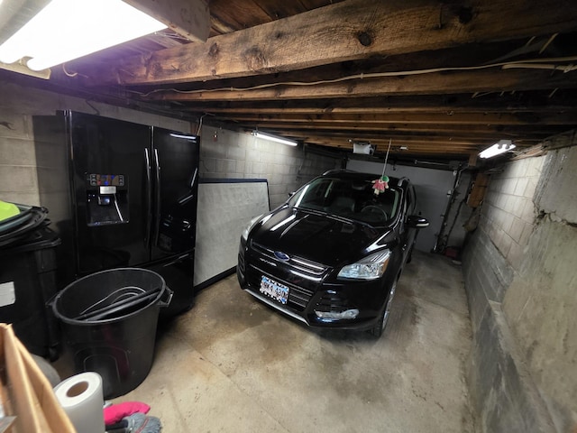 142 W Summit St, Lead, SD 57754 - garage featuring black refrigerator with ice dispenser