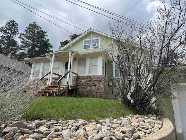 142 W Summit St, Lead, SD 57754 - view of front of house featuring stone siding, stucco siding, and a front yard