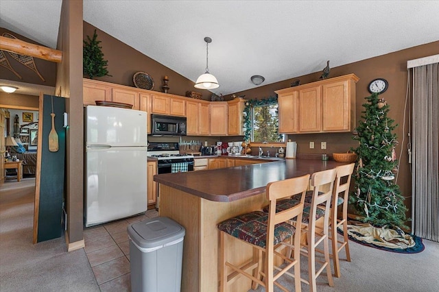 326 Nob Hill Rd, Spearfish, SD 57783 - kitchen featuring freestanding refrigerator, black microwave, range with gas cooktop, light colored carpet, and dark countertops