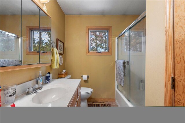 326 Nob Hill Rd, Spearfish, SD 57783 - bathroom featuring toilet, vanity, enclosed tub / shower combo, and baseboards
