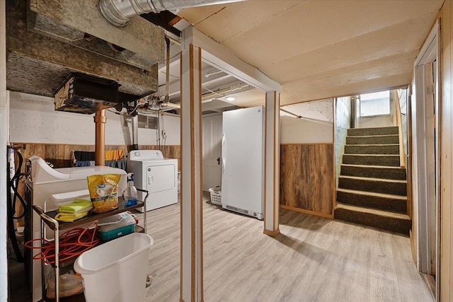 24 Mckinley St, Deadwood, SD 57732 - basement with freestanding refrigerator, wood walls, washing machine and clothes dryer, wood finished floors, and wainscoting