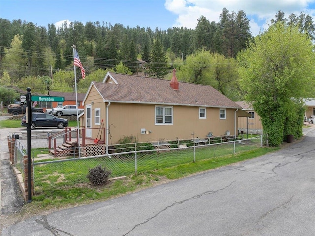 24 Mckinley St, Deadwood, SD 57732 - view of side of property with a chimney and a view of trees